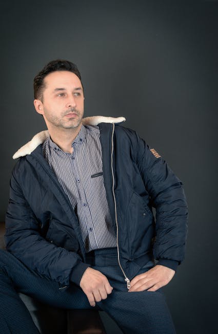 Adult man exercising with dumbbells in a gym, focused on fitness training.